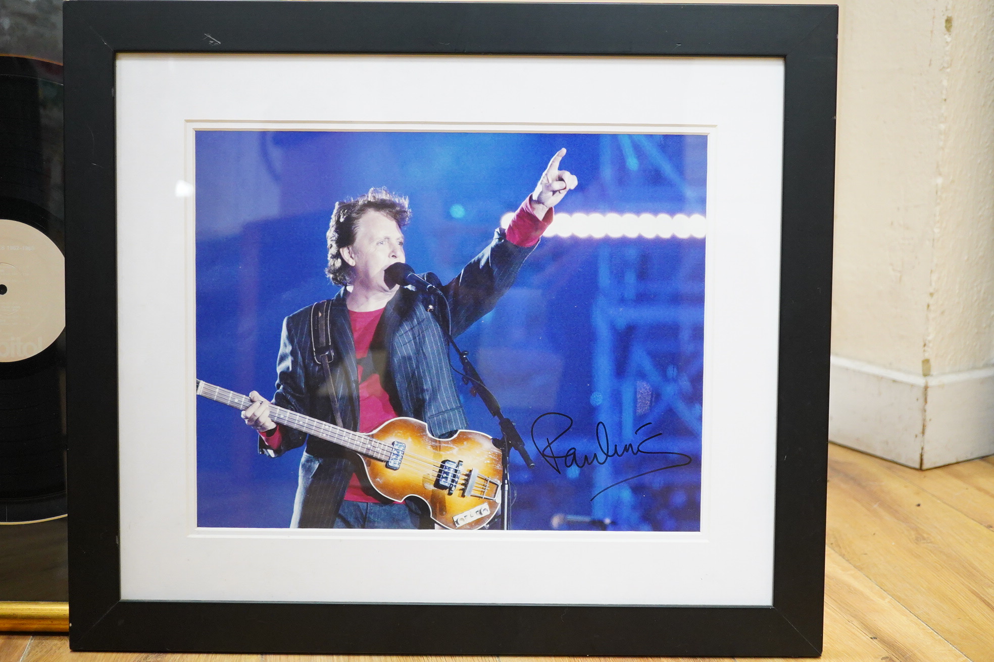 Three framed Beatles autographs; a framed signed album (missing Lennon), 84 x 44cm overall a photograph of Paul McCartney and a photograph of Ringo Starr, both signed across the image